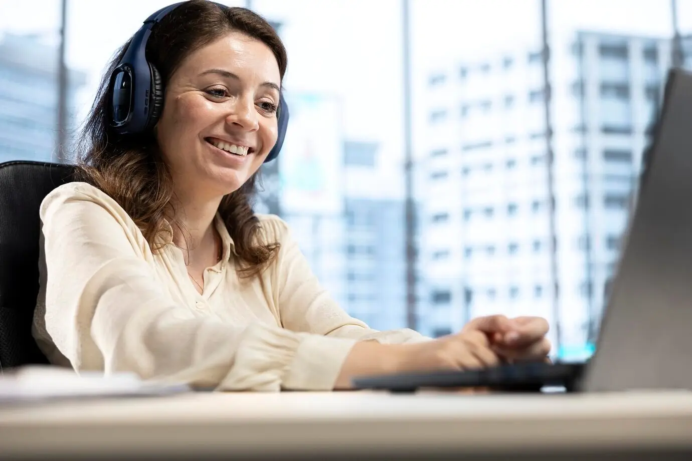 Selbstbewusste, zufriedene Unternehmerin, die mit ihrem Lieblingshörbuch Spaß hat.